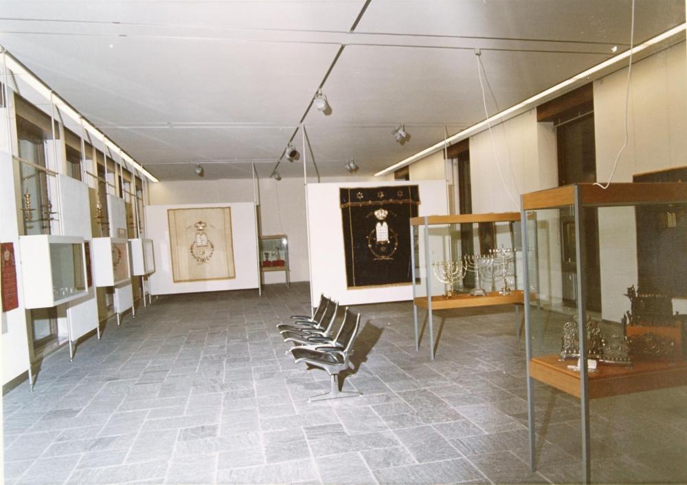 View of an exhibition hall with vitrines and seats