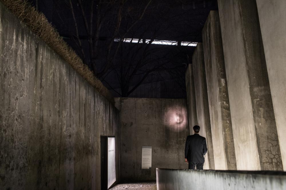 A member of the security team shining a flashlight inside the Garden of Exile. 