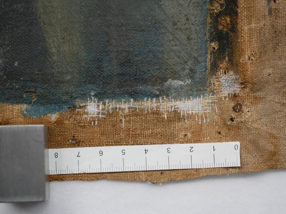 Close-up of the canvas with threads connected to the original fabric closing the holes