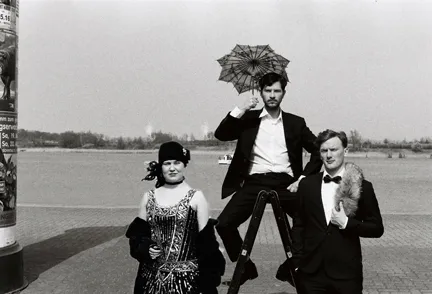 A black and white photo featuring a woman and two men.