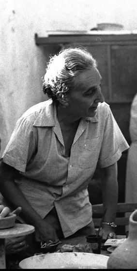 Black and white photo of a woman leaning forward. She is looking to her left side.