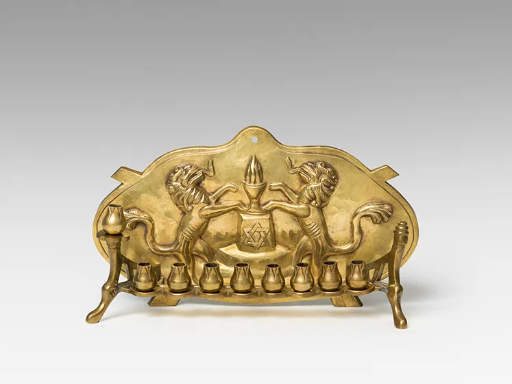 Golden Hanukkah candlestick with decorations.