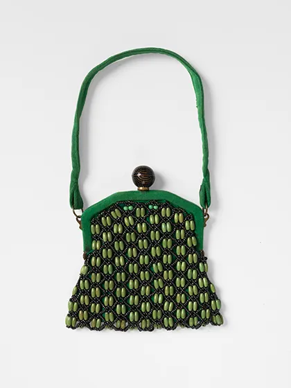 Homemade bead bag made from green and black beads and fabrics.