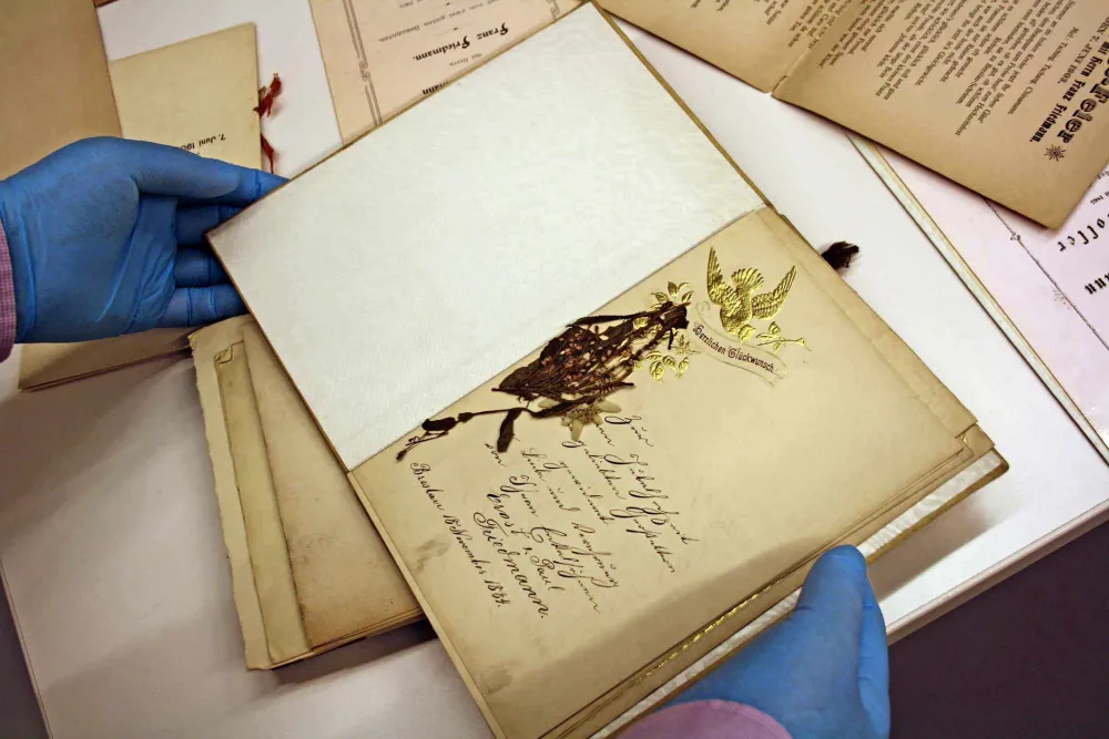 Hands holding an old book.