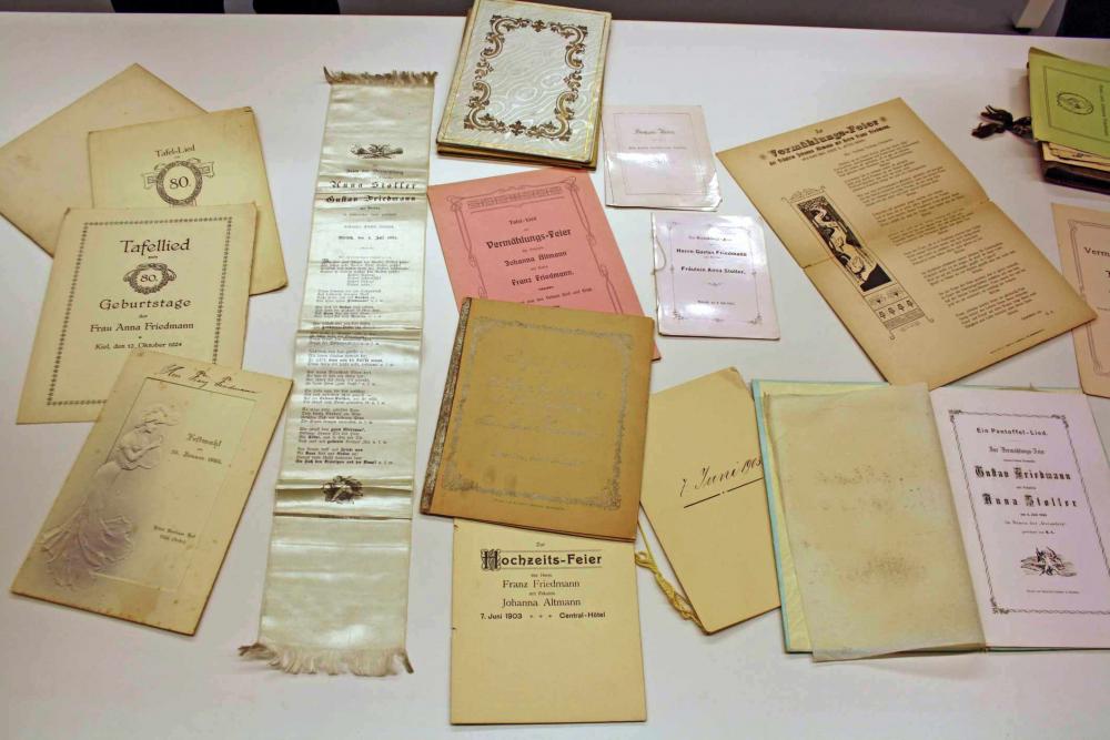 Various old documents lie on a table.