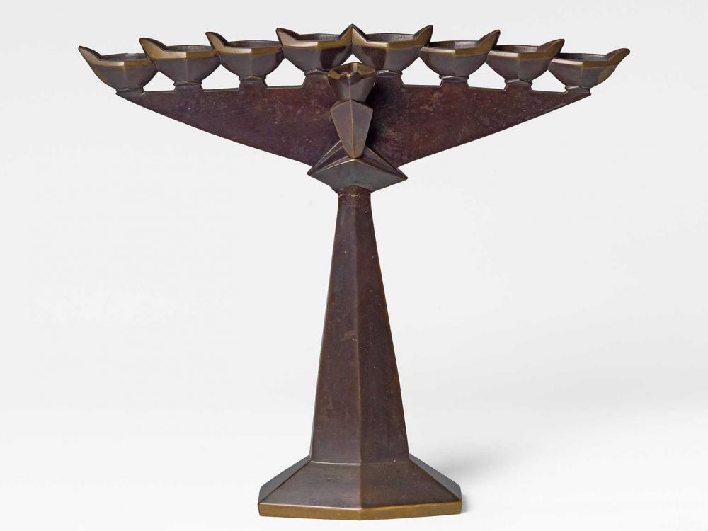 Modern Hanukkah candlestick cast from brass and patinated.
