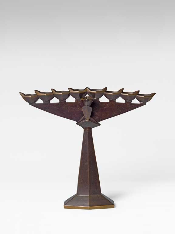 Modern Hanukkah candlestick cast from brass and patinated