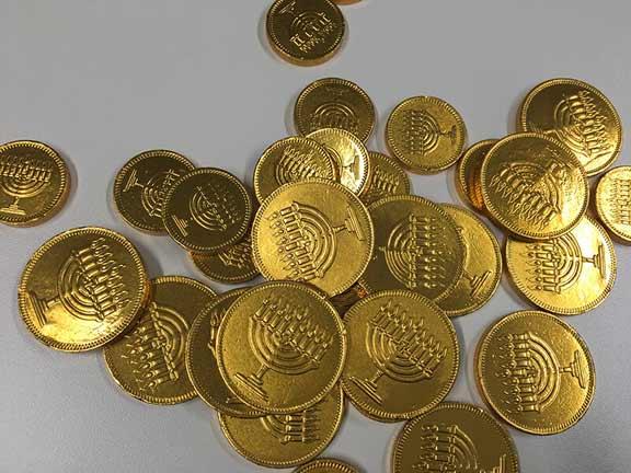 Chocolate coins. These are wrapped in shiny golden foil embossed with Hanukkah lamps