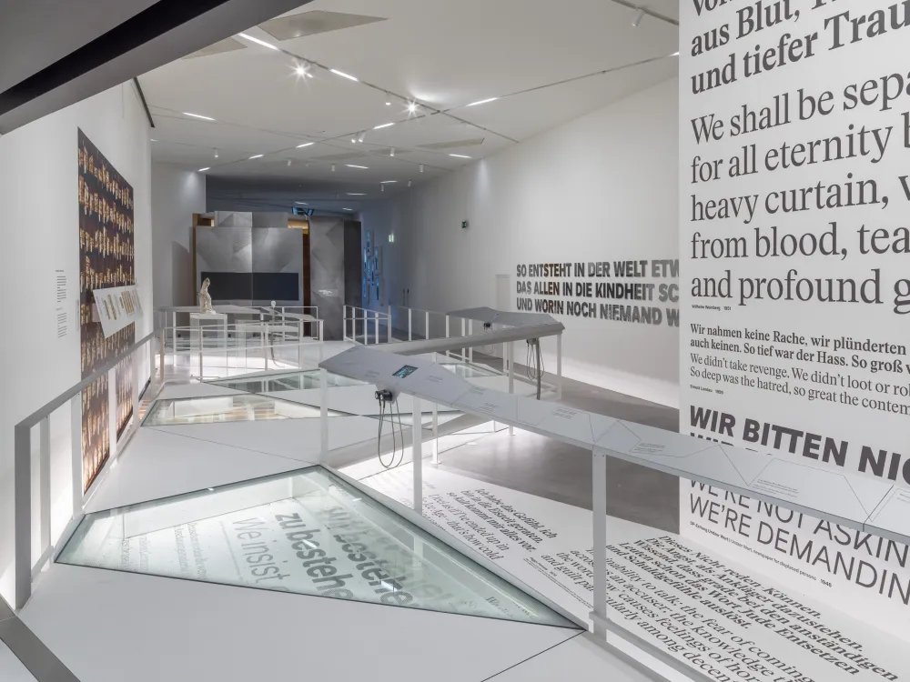 Long exhibition room, on the right wall is writing in large letters