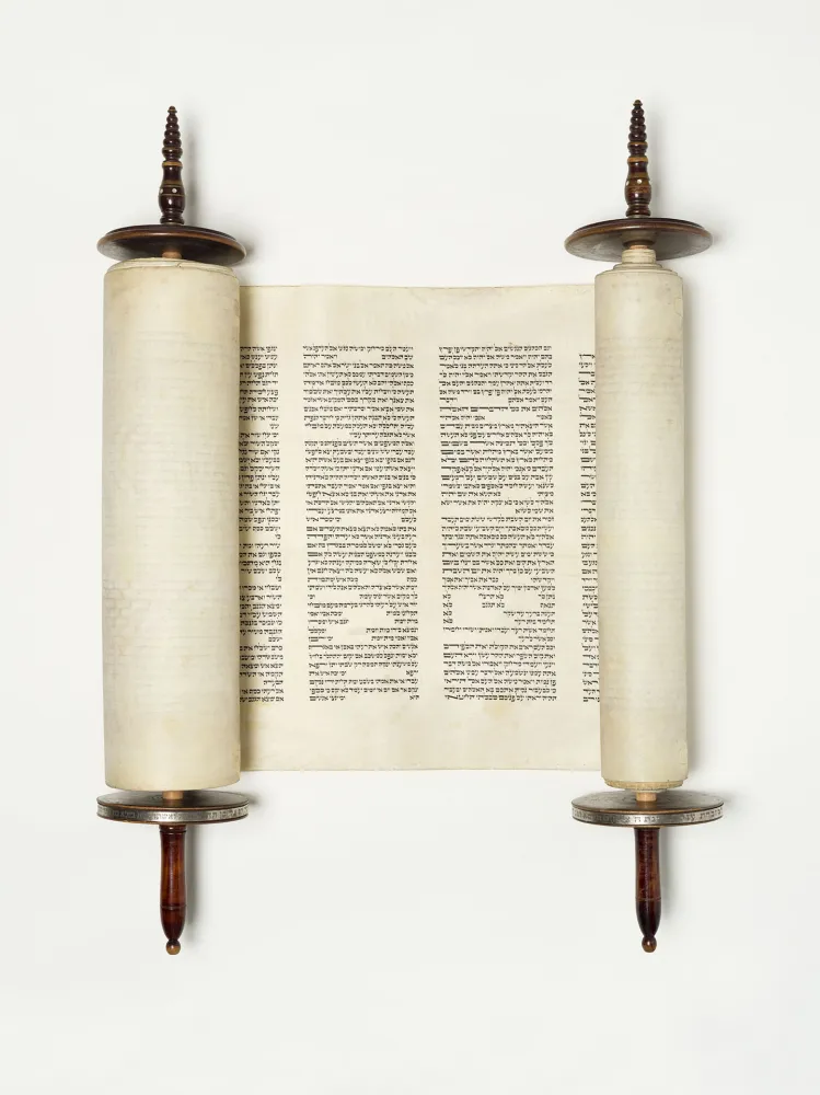 Torah scroll with wooden handles and Hebrew characters