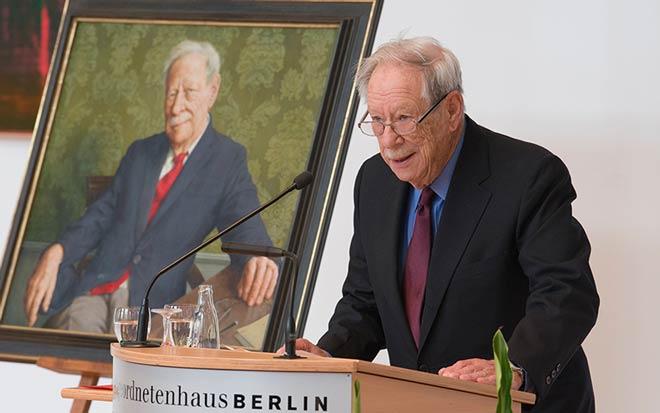 W. Michael Blumenthal in front of his portrait.