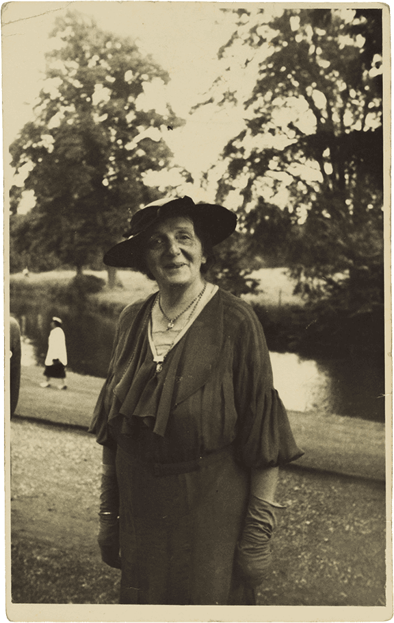 Historical black and white photograph of an elderly lady wearing a hat.