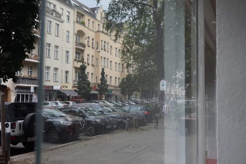 Color photo: View through storefront of prewar Berlin apartment buildings