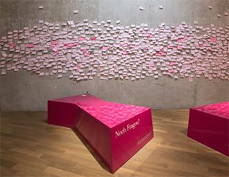 A wall with pink post-it notes