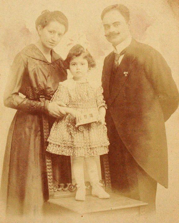 Studio portrait of a woman and a man with a child, about four years old