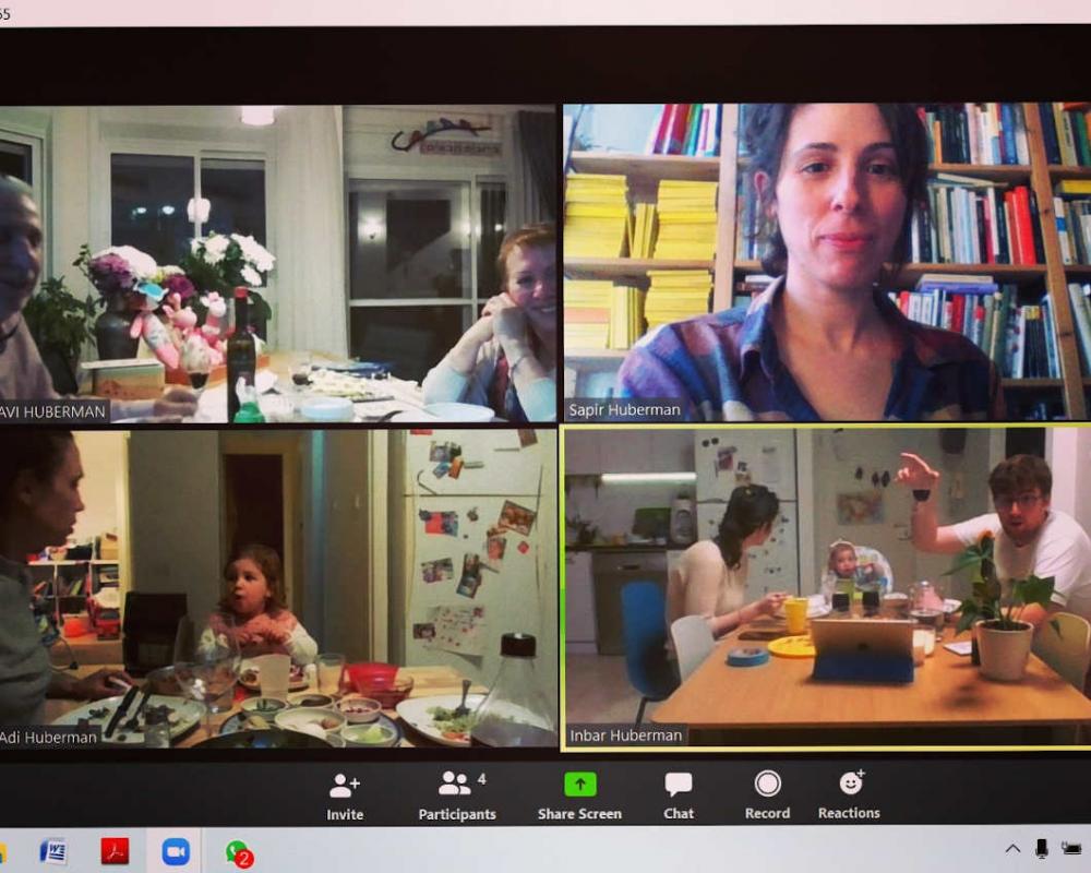 Screenshot of a video chat with four windows in which people can be seen.