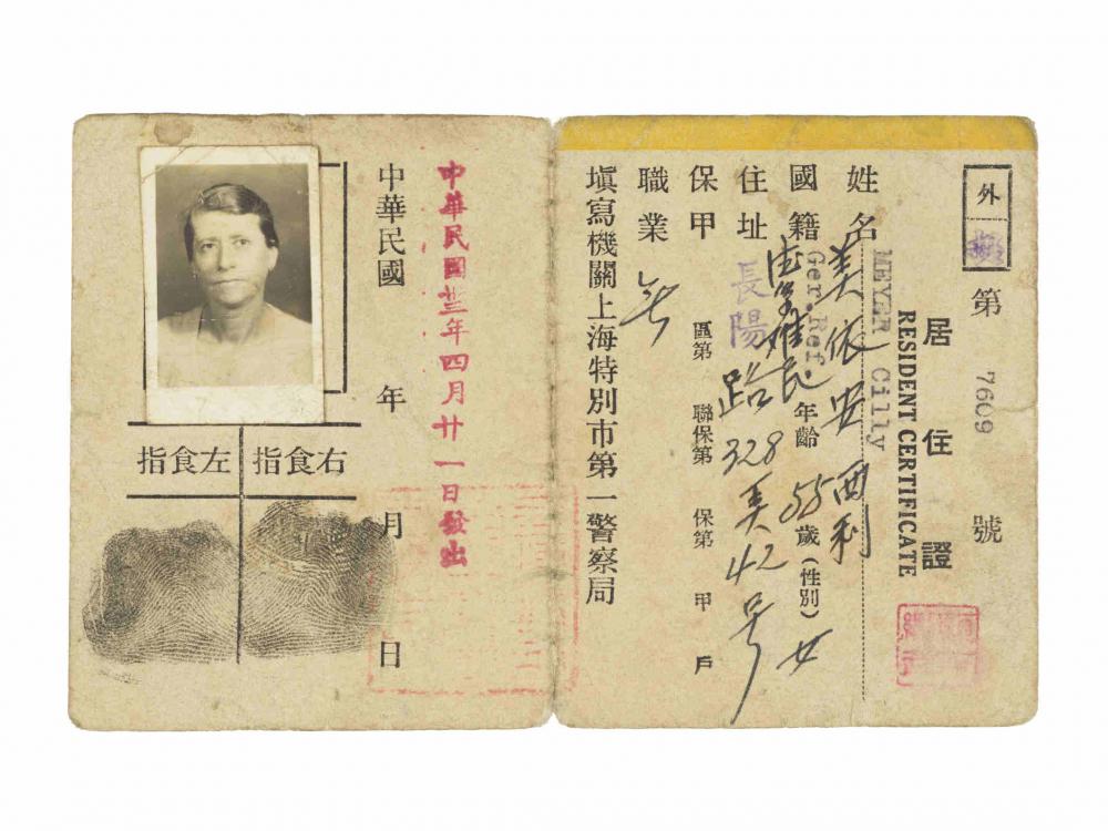 Papierausweis mit Passfoto einer Frau und chinesischer Schrift