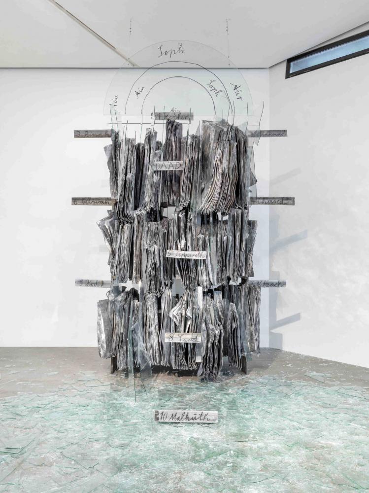 sculpture made of metal and glass, shards on the floor