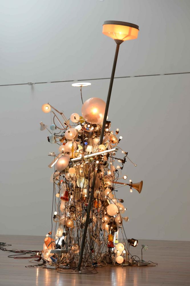 A figure resembling a human being, consisting of a myriad of light bulbs.