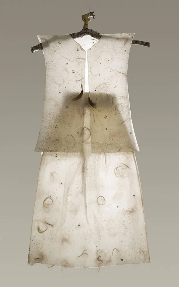 Photo of a work of art: A dress made of Japanese paper, hair, dirt, film and threads on a crude hanger. The hanger is hooked into a loop so that the small seems to float in space.