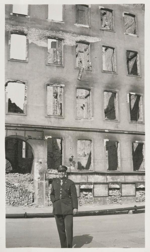 Bob Kunzig outside the ruins of a bombed apartment building