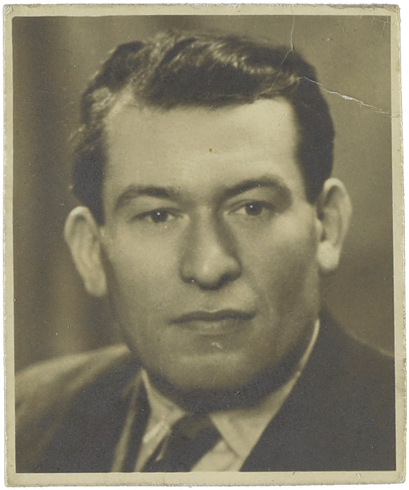 Black and white portrait of a white man with combed back hair.