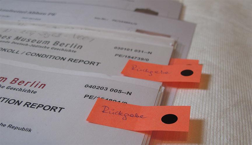 A stack of protocols, some of them with hand-written sticky notes that say “return.”