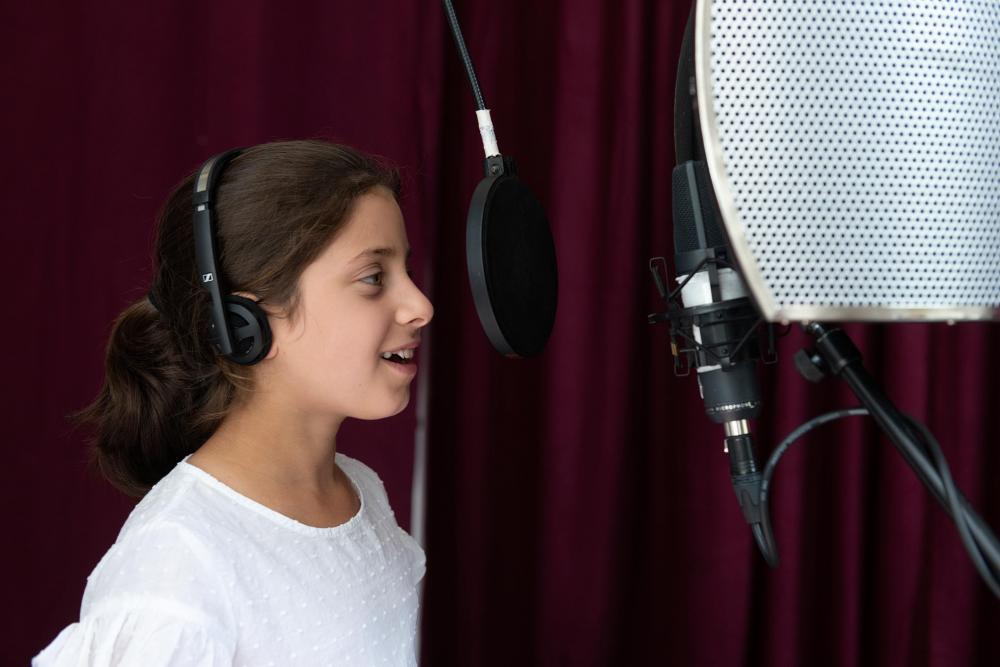 A girl records the radio play.
