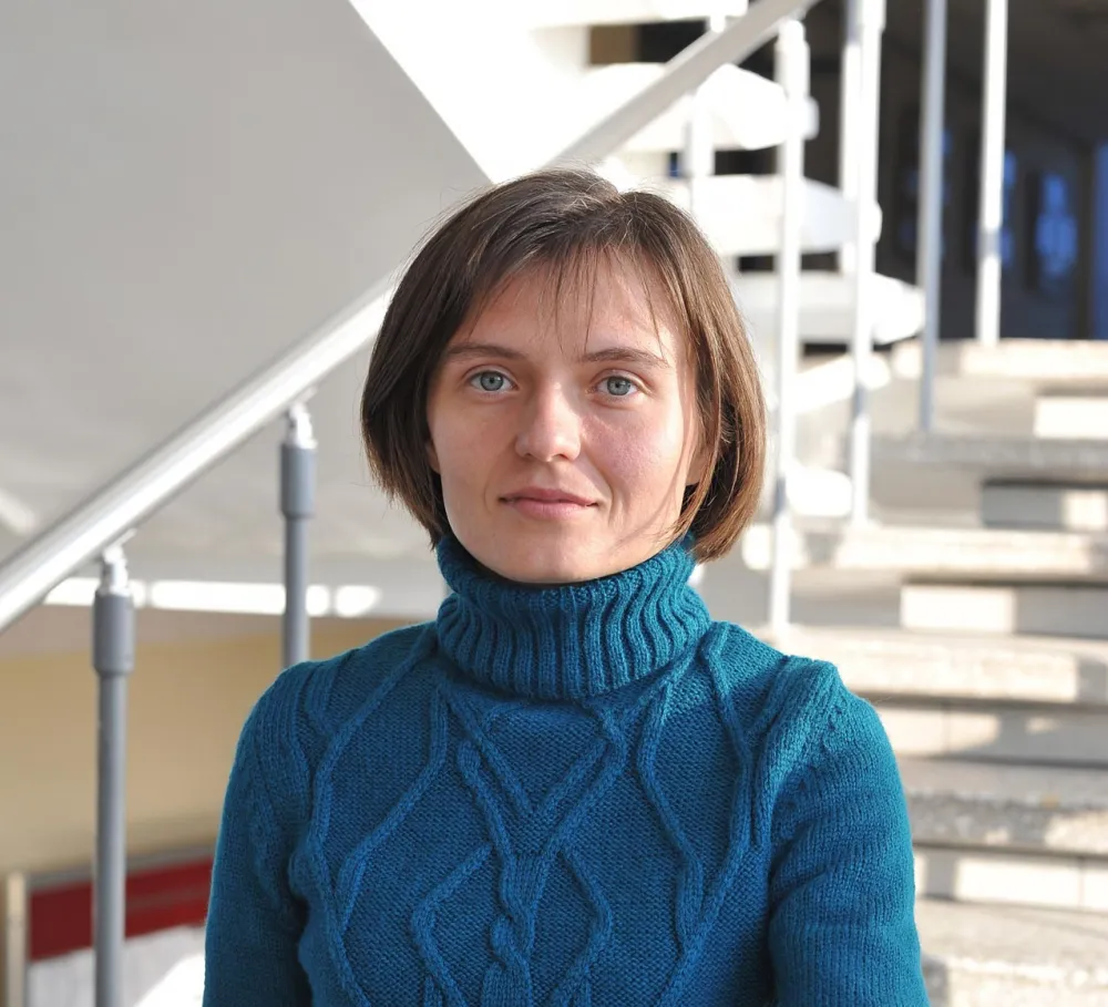Portrait of Tetiana Portnova in a stairwell.
