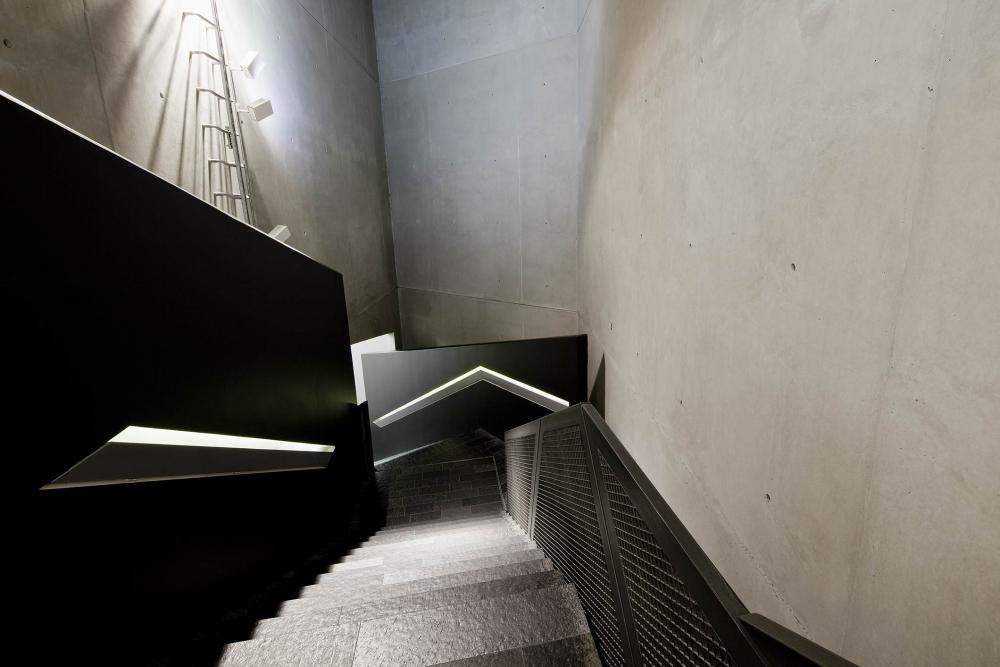 A downwards view of the winding staircase leading to the permanent exhibit