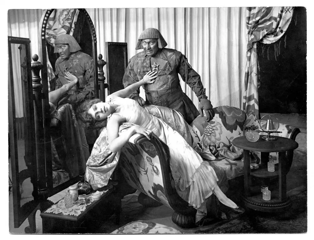 The Golem looks at a half-lying dancer
