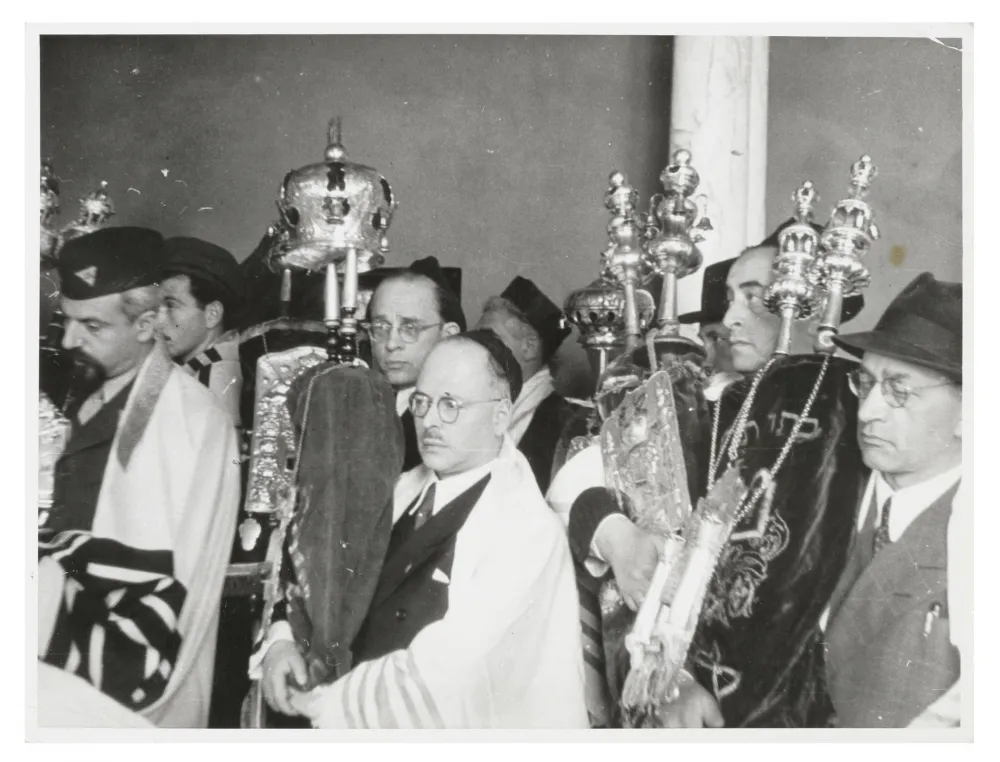 Black-and-white photograph of a group of people at the reconsecration of a synagogue