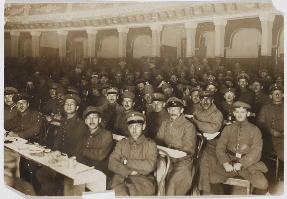 Historical black and white photograph of a group of uniformed men looking at the camera