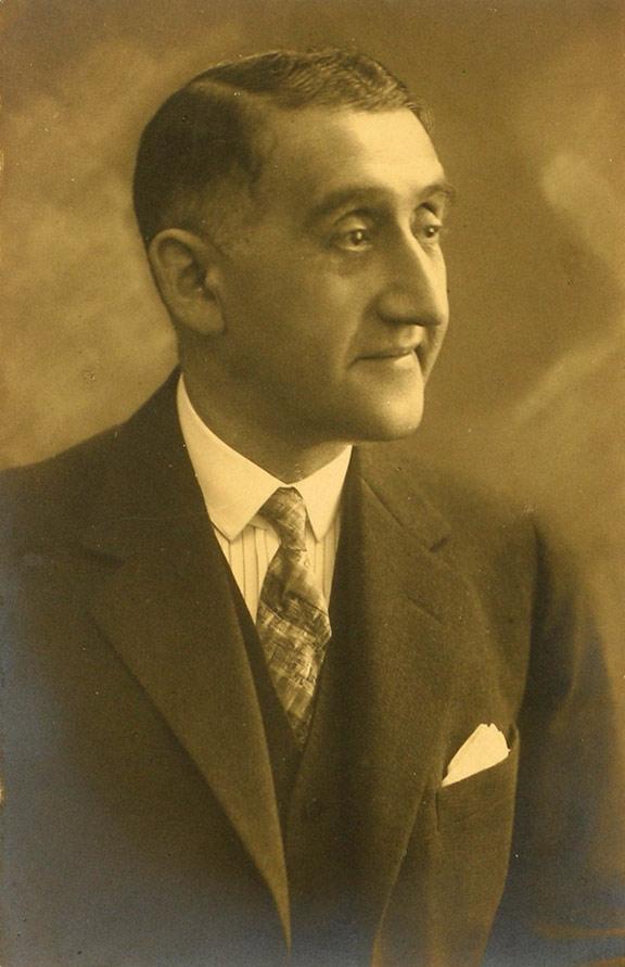Portrait photo of a man with suit and tie in half profile