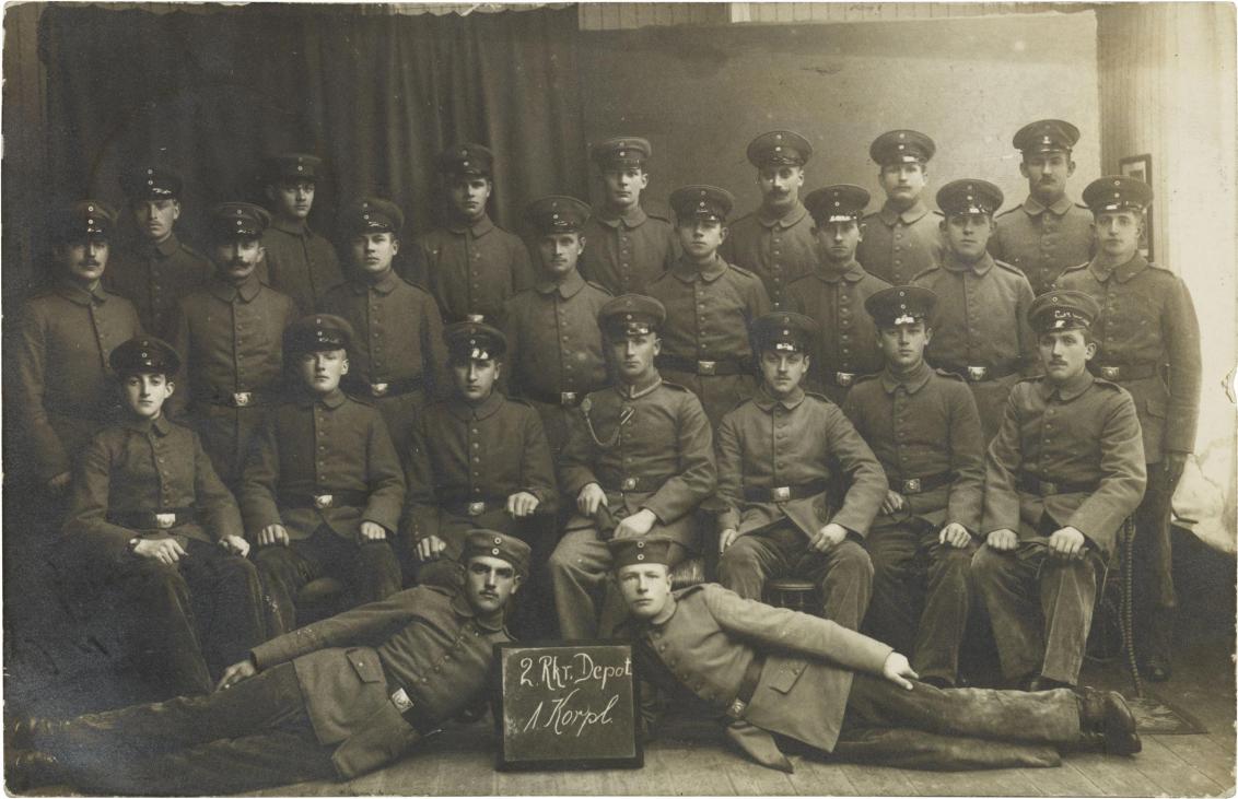 Black-and-white studio photograph: twenty-four soldiers in uniform