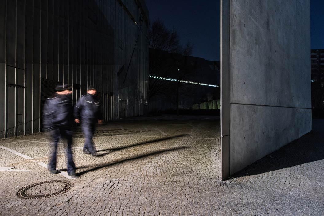 Two blurred Policewomen wakling along the museum. 