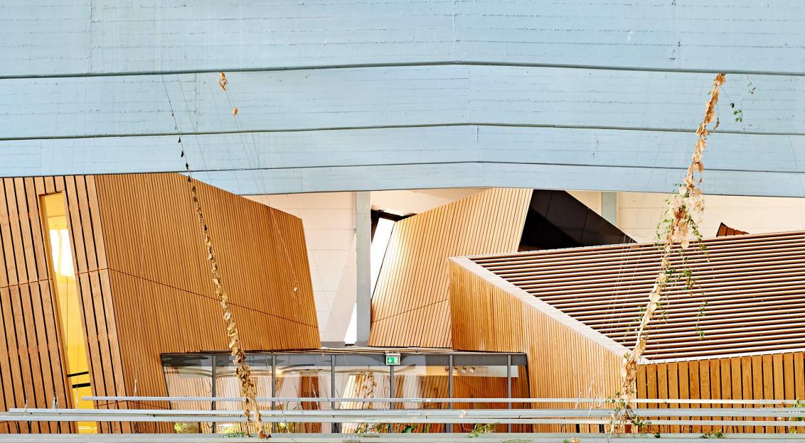 Interior view of the W. Michael Blumenthal Academy with three slanted wooden cubes