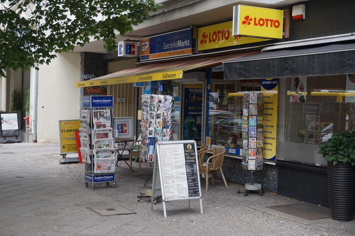 Color photo: Convenience store with awning and signage