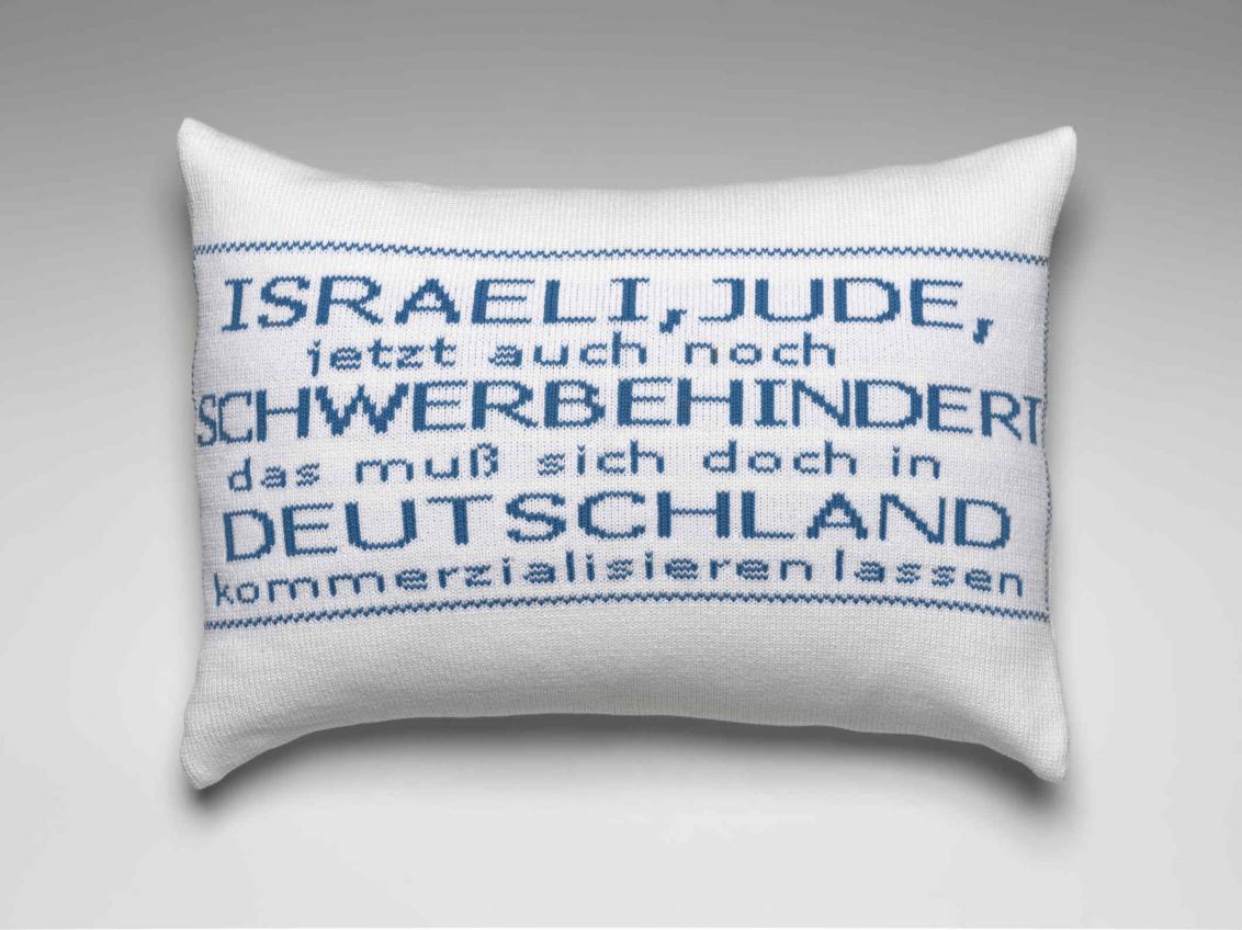  White pillow with embroidered blue text