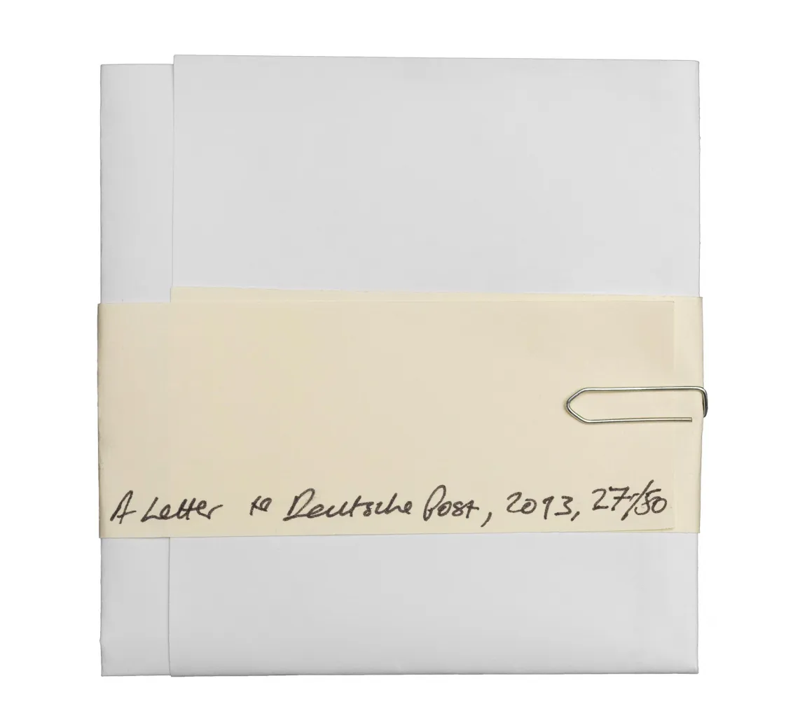 Folded letter with a paperclip with the handwritten words "A letter to Deutsche Post" written in the middle