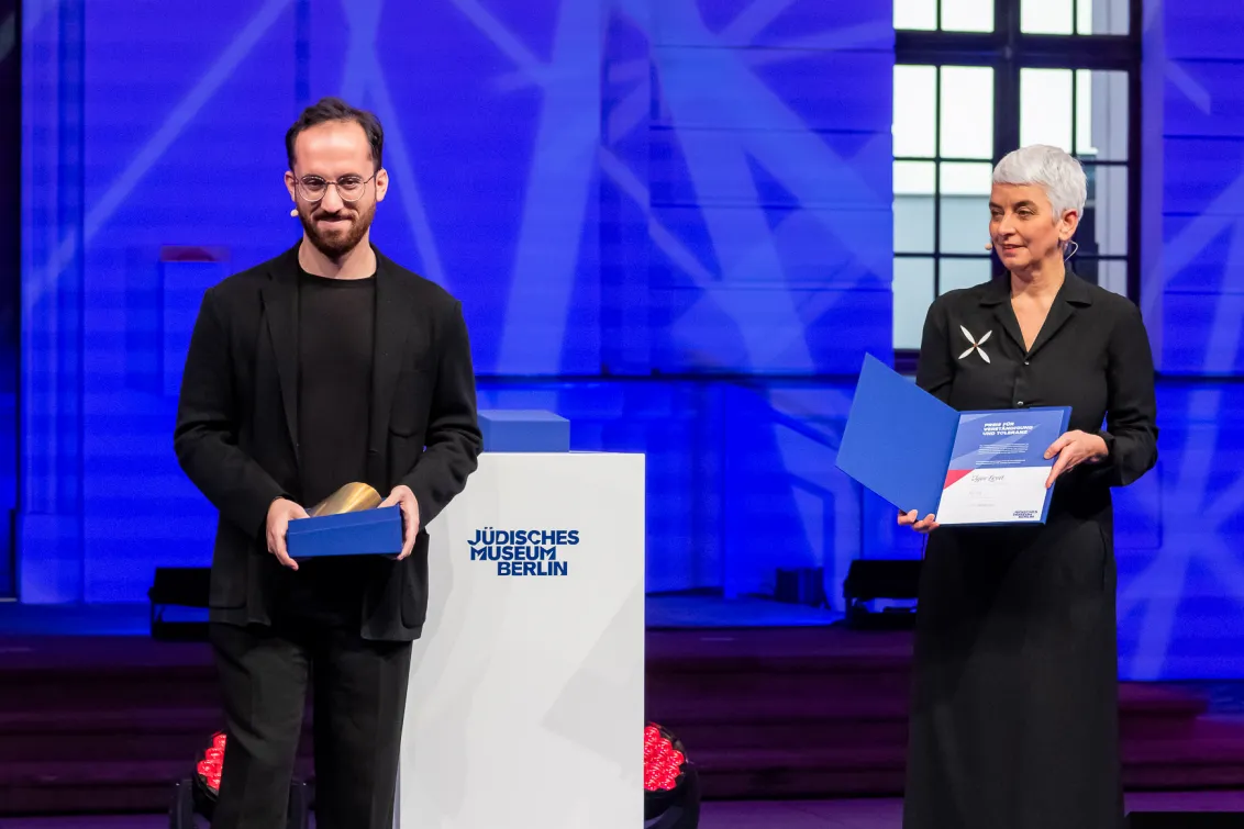 Igor Levit and Hetty Berg stand on a stage