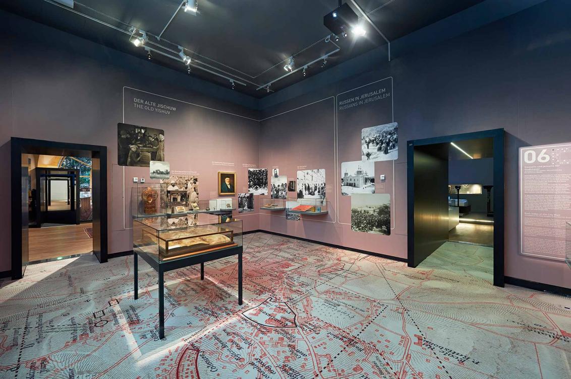 Exhibition room with historical photographs and showcases.