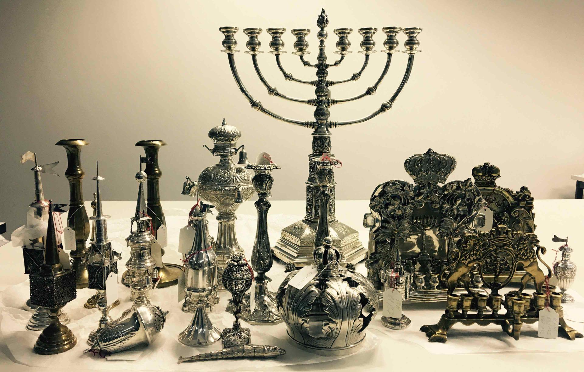 Various metal objects, including a Hanukkah chandelier.