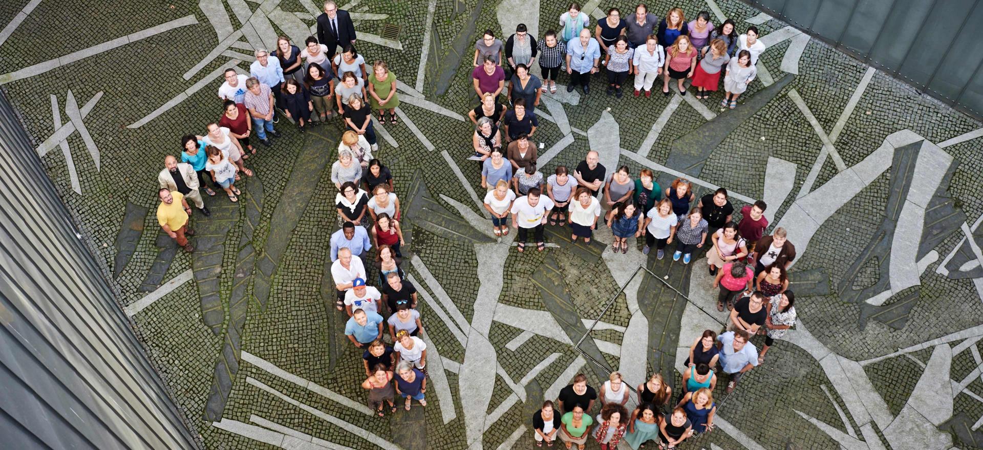 Aerial view, a group of people form the number 15.