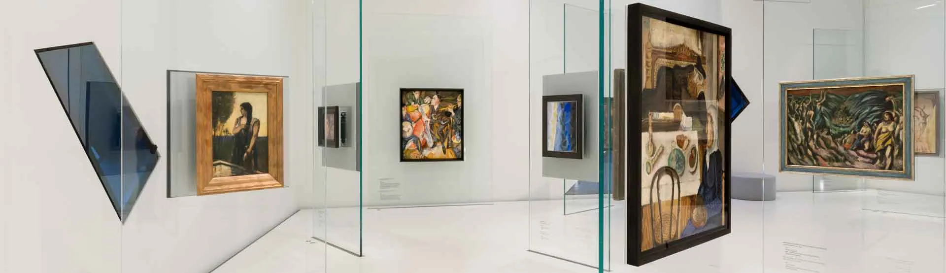Exhibition view of the permanent exhibition, in which several paintings are displayed throughout the room. Max Oppenheimer's &lsquo;Jazz Band&rsquo; painting hangs at the very back of the room.