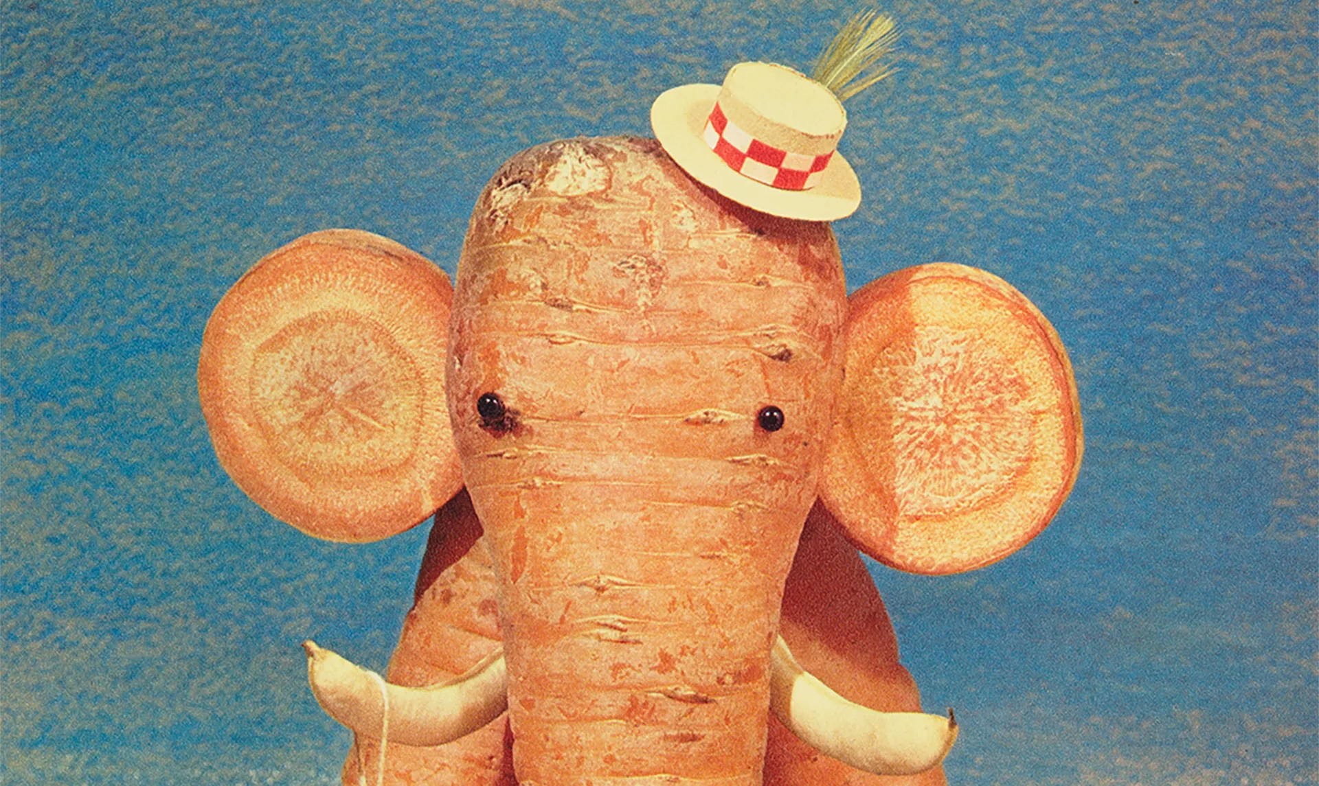 A sculpture composed of carrots and decorative materials, arranged in the form of an elephant.