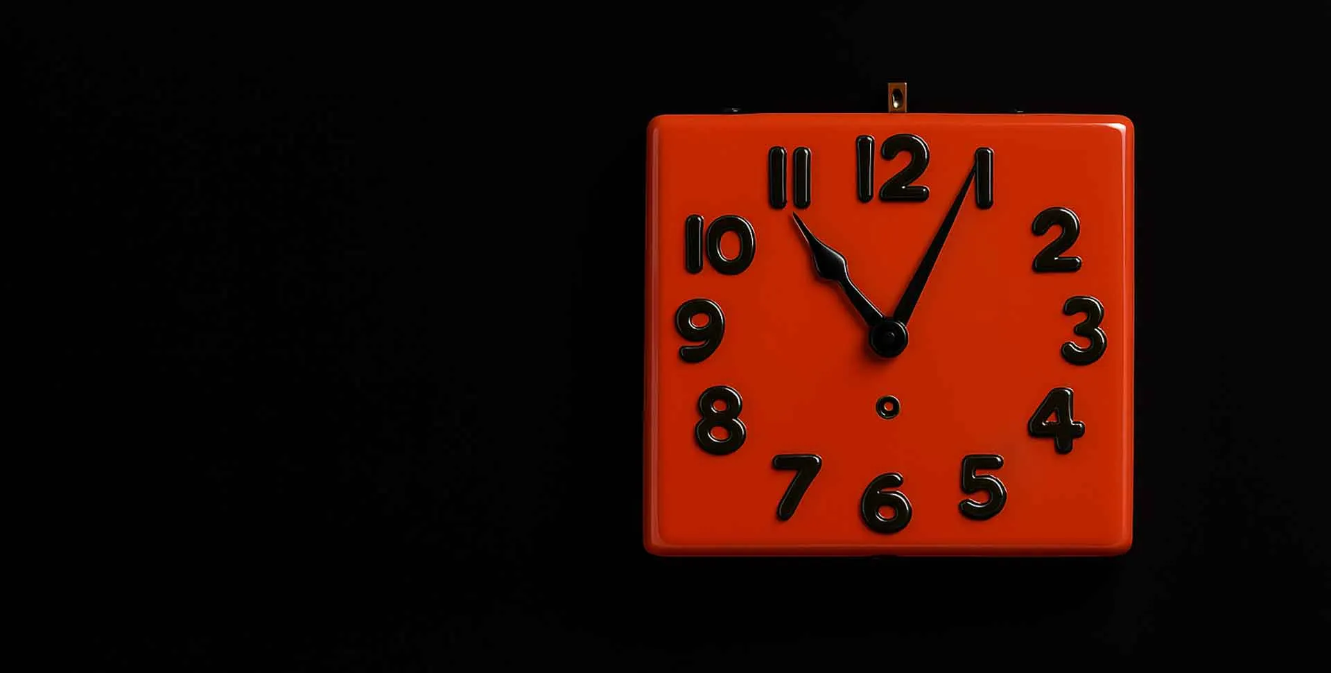 Orange coloured clock made out of ceramic.