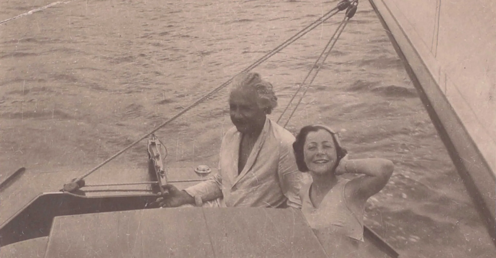Black and white photograph of Albert Einstein and a young woman (Irene Salinger) on a sailboat.