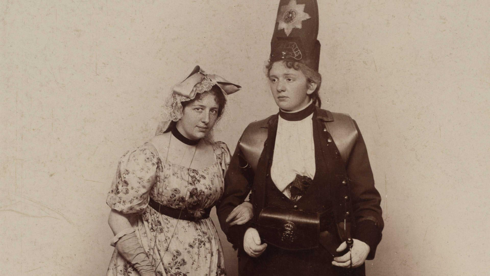 Historical black and white photograph of two women in costumes.
