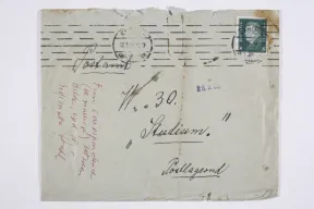 Old envelope. It is handwritten in black and red. 